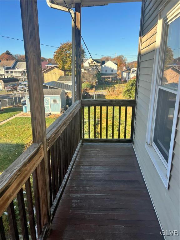 wooden terrace with a yard