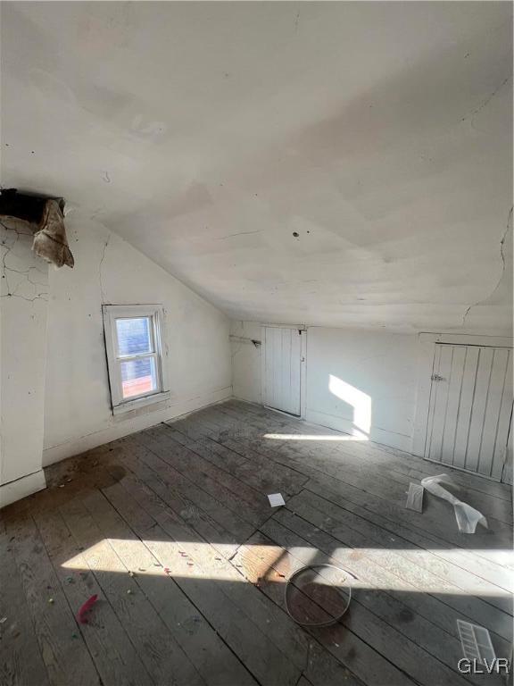 bonus room featuring hardwood / wood-style flooring and vaulted ceiling