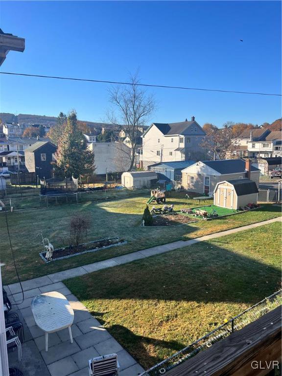 view of yard with a storage unit, a trampoline, and a patio