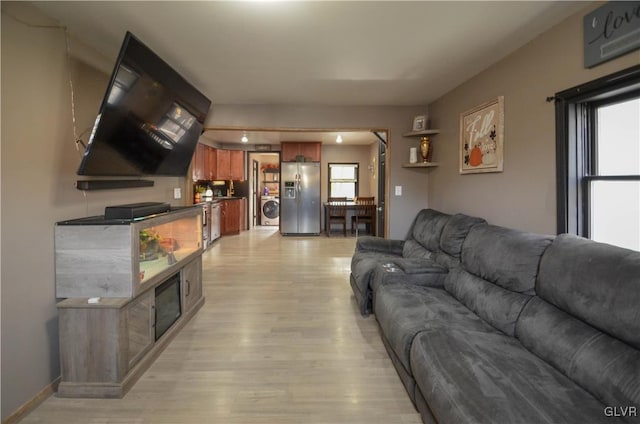 living room featuring light hardwood / wood-style floors and washer / clothes dryer