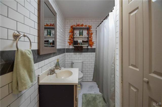 bathroom with vanity, ornamental molding, tile walls, and toilet