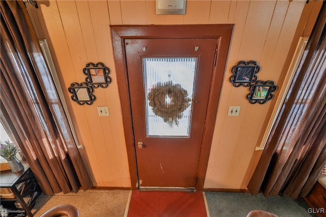 entryway with wooden walls