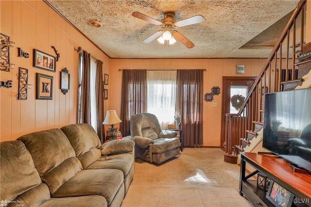 living room with a textured ceiling and ceiling fan