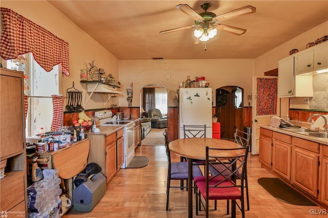 kitchen featuring white appliances, light hardwood / wood-style flooring, ceiling fan, and sink