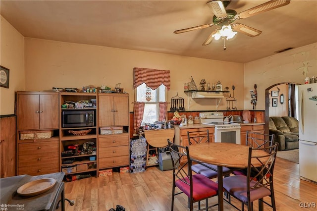 dining room with ceiling fan and light wood-type flooring