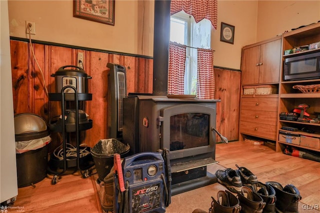 living room with hardwood / wood-style floors and wooden walls