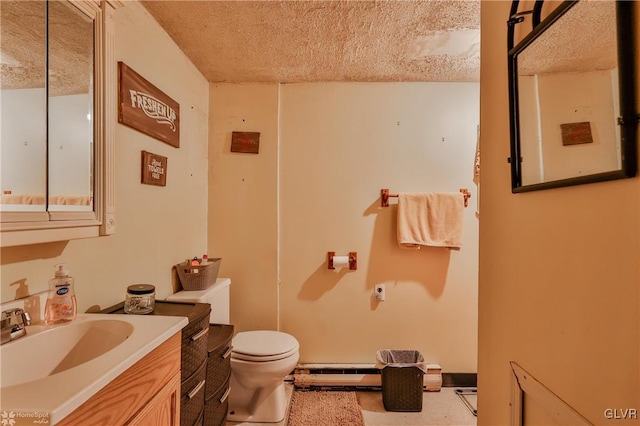 bathroom with a baseboard heating unit, vanity, a textured ceiling, and toilet