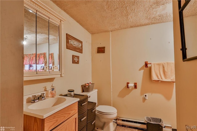 bathroom featuring vanity, toilet, a textured ceiling, and a baseboard radiator