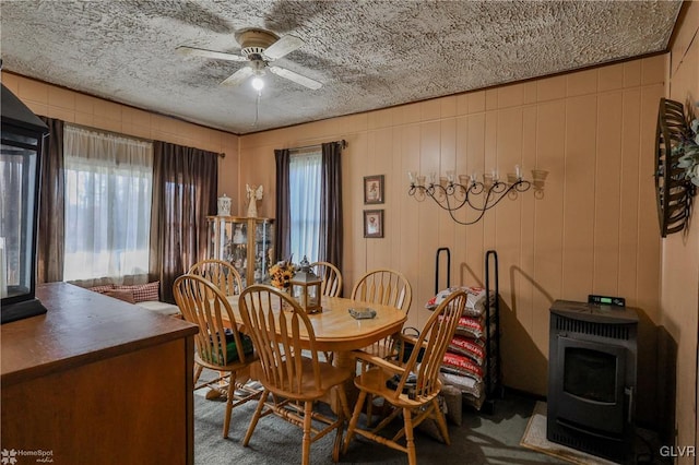 dining room featuring ceiling fan, carpet, and a textured ceiling