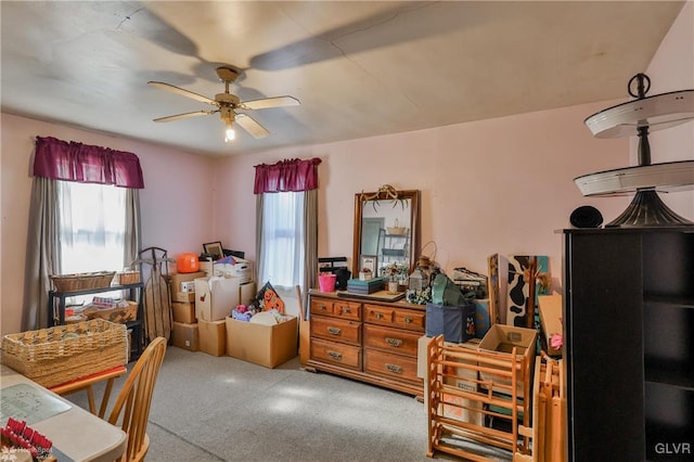 carpeted bedroom with multiple windows and ceiling fan