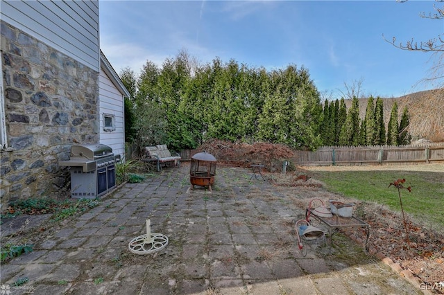 view of patio / terrace with a fire pit and a grill