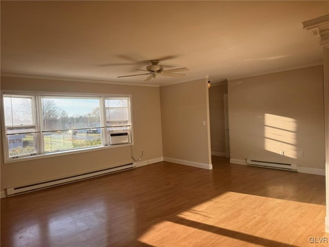 spare room featuring baseboard heating, ceiling fan, crown molding, and dark wood-type flooring