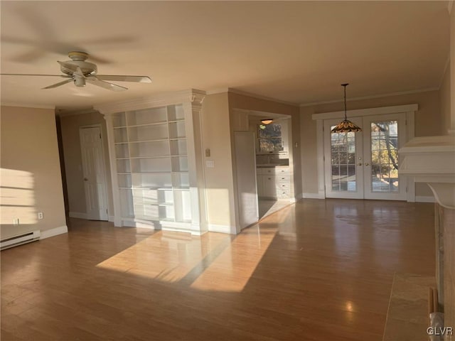 spare room with french doors, crown molding, ceiling fan, a baseboard radiator, and wood-type flooring