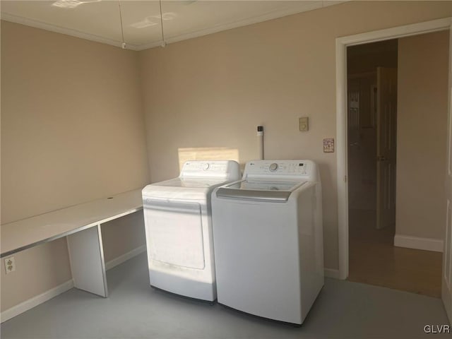 laundry area featuring washing machine and clothes dryer and ornamental molding