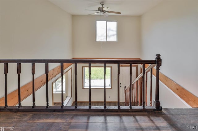 stairs with ceiling fan and plenty of natural light