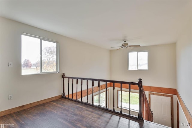 unfurnished room featuring ceiling fan and dark wood-type flooring