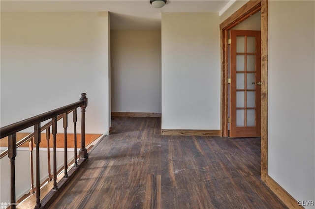 corridor with french doors and dark hardwood / wood-style floors