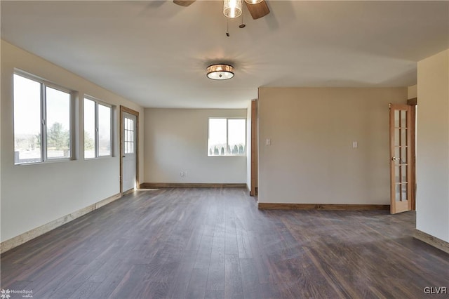 empty room featuring french doors, dark hardwood / wood-style flooring, and ceiling fan