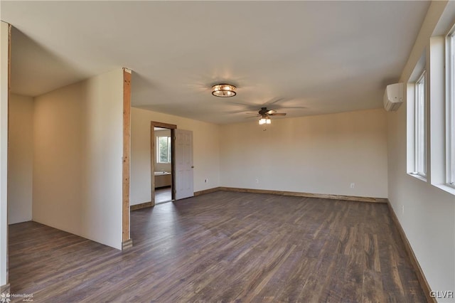 spare room featuring a wall mounted air conditioner, ceiling fan, and dark wood-type flooring