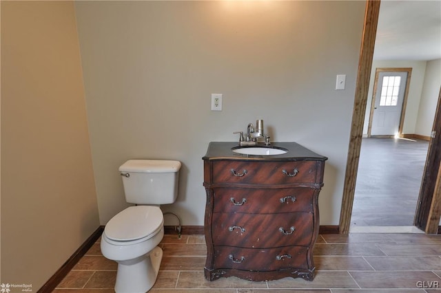 bathroom featuring hardwood / wood-style flooring, vanity, and toilet