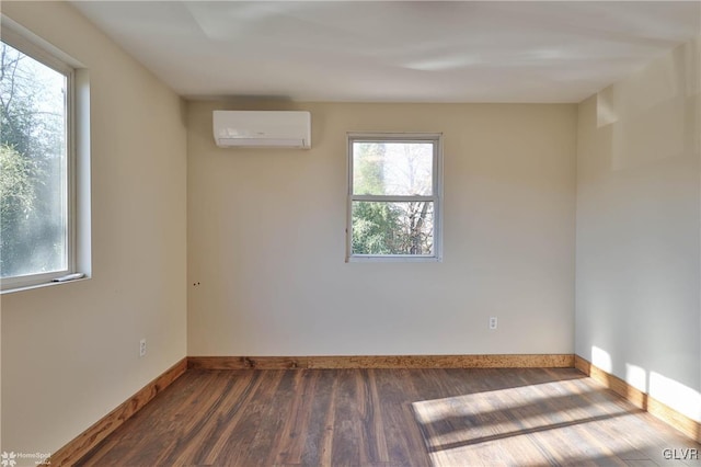 unfurnished room with a wall mounted AC and dark wood-type flooring