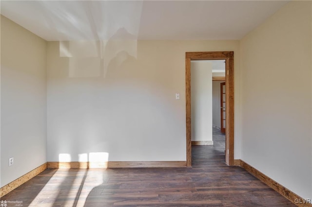 unfurnished room with dark hardwood / wood-style floors