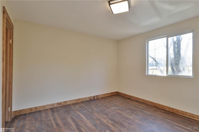 spare room with dark hardwood / wood-style flooring