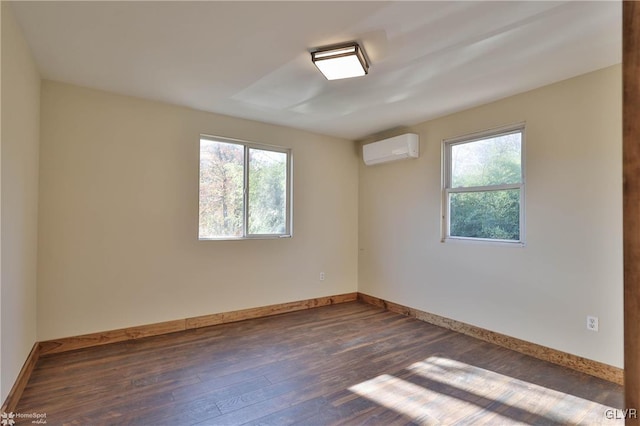 unfurnished room with dark wood-type flooring and a wall mounted AC