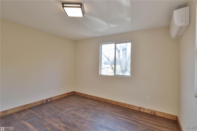 spare room with dark wood-type flooring and a wall mounted air conditioner