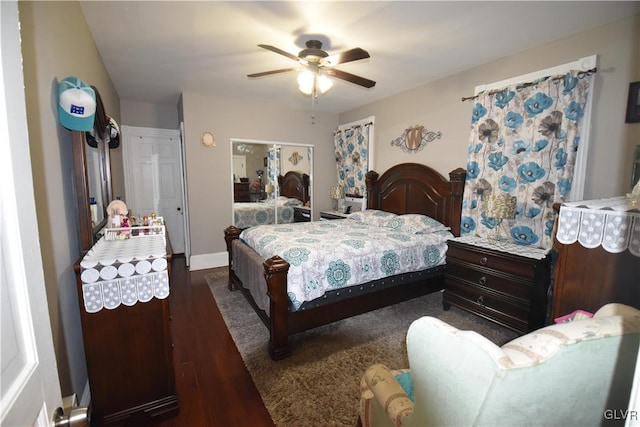 bedroom with ceiling fan, a closet, and dark wood-type flooring