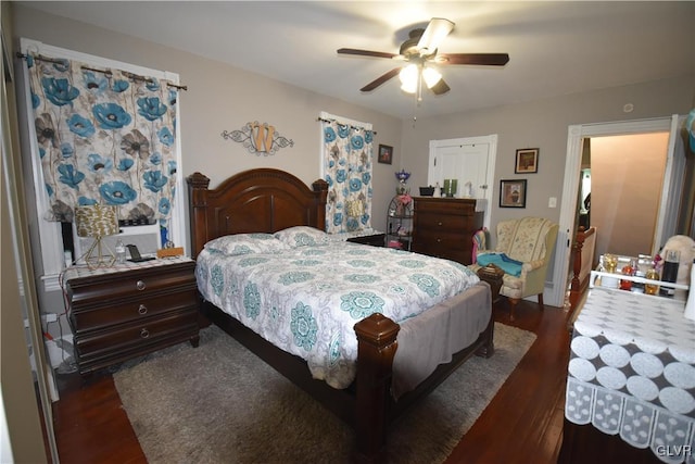 bedroom with dark hardwood / wood-style flooring and ceiling fan