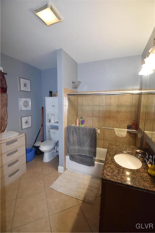 full bathroom featuring toilet, vanity, tile patterned floors, and shower / bathtub combination