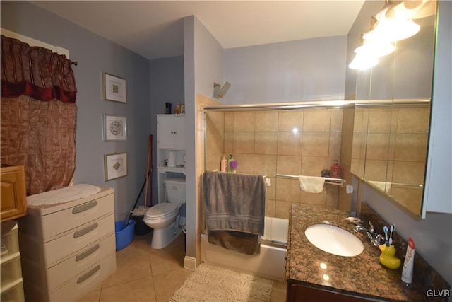 full bathroom with vanity, tile patterned floors, toilet, enclosed tub / shower combo, and tile walls