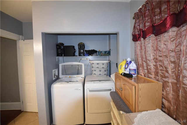 laundry area with washer and dryer and light tile patterned flooring