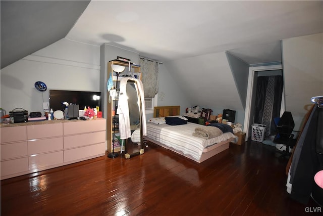 bedroom featuring dark hardwood / wood-style flooring and vaulted ceiling