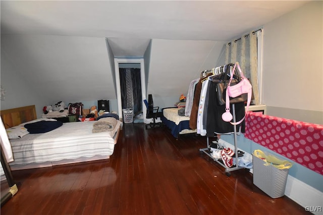 bedroom with lofted ceiling and dark wood-type flooring