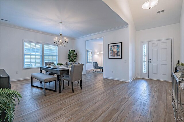 3855 Victors Way, Bethlehem Twp, PA 18045 - dining space featuring hardwood / wood-style floors, vaulted ceiling, an inviting chandelier, and ornamental molding
