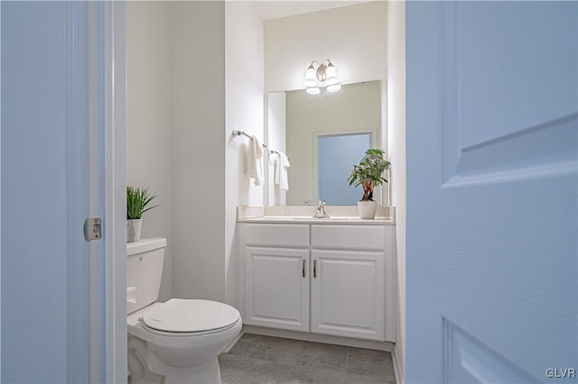 bathroom with tile patterned floors, vanity, and toilet