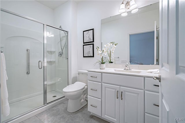 bathroom with vanity, an enclosed shower, and toilet