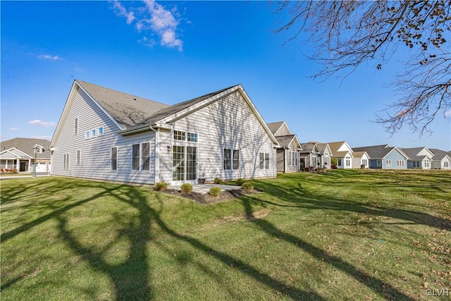 back of house with a lawn