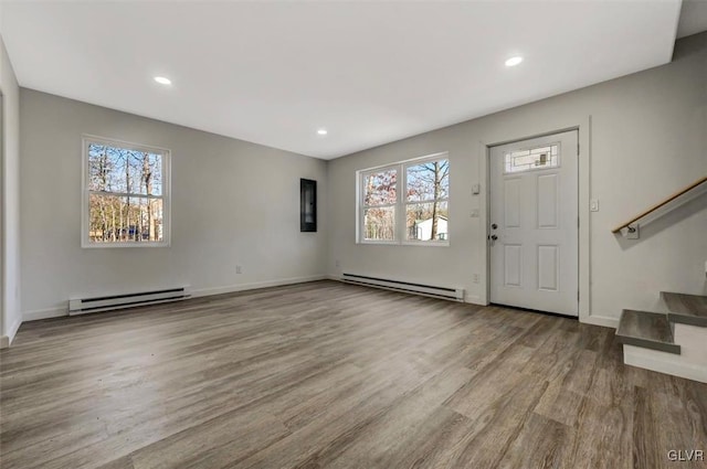 entrance foyer with light hardwood / wood-style flooring and a baseboard radiator