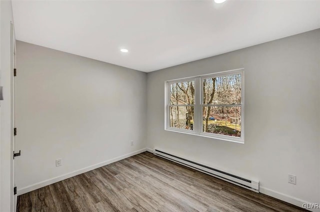 spare room featuring hardwood / wood-style floors and baseboard heating