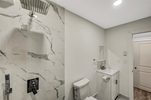 bathroom with wood-type flooring, vanity, and toilet