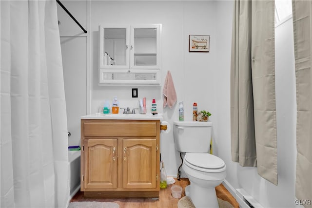 full bathroom with hardwood / wood-style flooring, vanity, toilet, and shower / tub combo with curtain