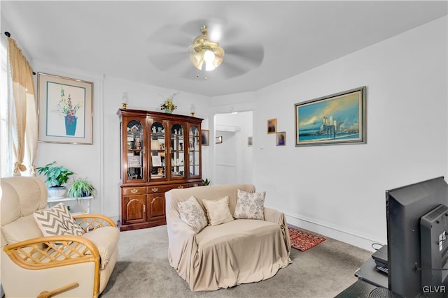 living room with light carpet and ceiling fan