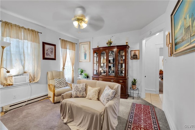 sitting room featuring light carpet, baseboard heating, and ceiling fan