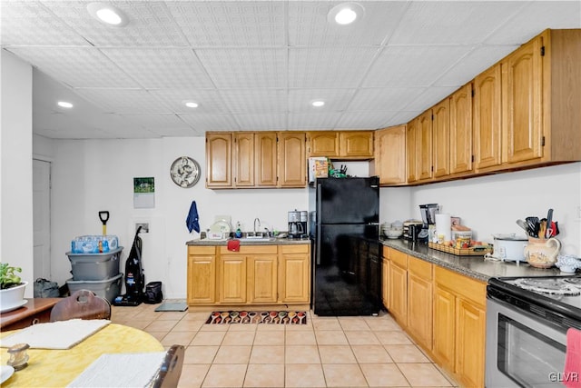 kitchen with black refrigerator, light tile patterned floors, white electric stove, and sink