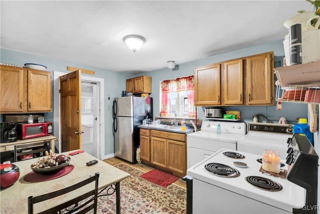 kitchen featuring stainless steel fridge, tasteful backsplash, sink, and washing machine and clothes dryer