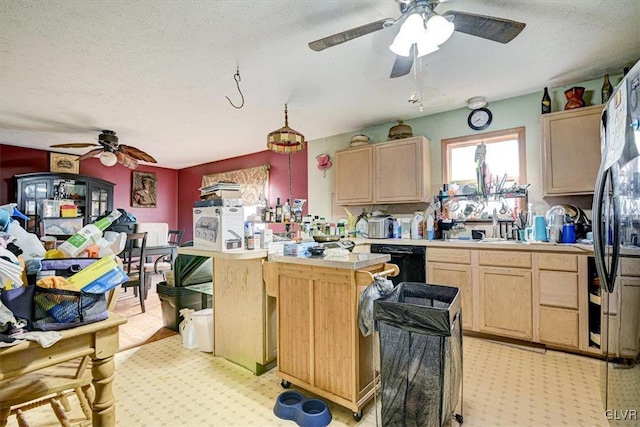 kitchen with light brown cabinetry, a textured ceiling, sink, dishwasher, and fridge