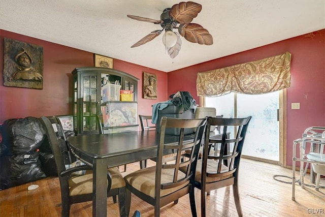 dining area with hardwood / wood-style flooring and ceiling fan